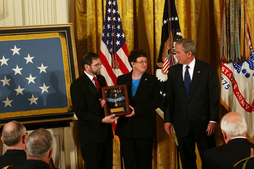 President George W. Bush shares a moment with Tom and Romayne McGinnis, of Knox, Pennsylvania, after presenting them the Congressional Medal of Honor in honor of their son, Private First Class Ross A. McGinnis, who was honored posthumously Monday, June 2, 2008, in the East Room of the White House. White House photo by Joyce N. Boghosian