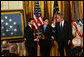 President George W. Bush shares a moment with Tom and Romayne McGinnis, of Knox, Pennsylvania, after presenting them the Congressional Medal of Honor in honor of their son, Private First Class Ross A. McGinnis, who was honored posthumously Monday, June 2, 2008, in the East Room of the White House. White House photo by Joyce N. Boghosian