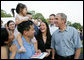 President George W. Bush stops to meet a young guest and her family at the annual Congressional Picnic on the South Lawn of the White House, Thursday evening, June 5, 2008, for members of Congress and their families. White House photo by Chris Greenberg