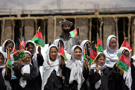 Future students of the Ayenda Learning Center wave flags and greet Mrs. Laura Bush during her visit to the construction site of the Ayenda Learning Center Sunday, June 8, 2008, in Bamiyan, Afghanistan. White House photo by Shealah Craighead