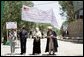 Mrs. Laura Bush, left, assists local officials with the ribbon cutting ceremony June 9, 2008 in Afghanistan at the ground-breaking ceremonies for the 1.96 kilometer Bamiyan road project through the bazaar. The new road will link up with a 1.72 kilometer road from the airport to the town center completed in 2007 with U.S. support. White House photo by Shealah Craighead