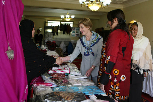 Mrs. Laura Bush greets local businesswomen as she tours the marketplace of the Arzu and Bamiyan Women’s Business Association on June 9, 2008 in Afghanistan. The carpets, embroidery and other Afghan wares are all made by women. White House photo by Shealah Craighead