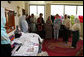 Mrs. Laura Bush speaks with Afghan women entrepreneurs during her visit to the marketplace of Arzu and Bamiyan Women's Business Association Sunday, June 8, 2008, in Afghanistan. White House photo by Shealah Craighead