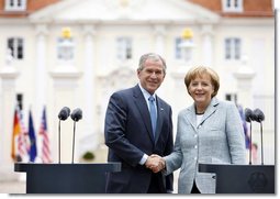 President George W. Bush and Germany's Chancellor Angela Merkel shake hands after participating in a joint press availability Wednesday, June 11, 2008, at Schloss Meseberg in Meseberg, Germany. White House photo by Eric Draper