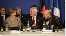 Mrs. Laura Bush, seated next to Afghanistan Foreign Minister Dr. Rangin Dadfar Spanta, speaks with Afghanistan President Hamid Karzai, right, during the International Conference in Support of Afghanistan Thursday, June 12, 2008, in Paris.  White House photo by Shealah Craighead