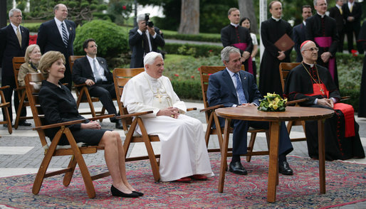 President George W. Bush and Mrs. Laura Bush meet June 13, 2008 in the Vatican Gardens with Pope Benedict XVI and Vatican Secretary of State Cardinal Tarcisio Bertone, where they watch the performance of The Pontifical Sistine Choir. White House photo by Shealah Craighead