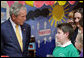 President George W. Bush speaks with a young student Monday. June 16, 2008, during his visit to the Lough Integrated Primary School in Belfast, Ireland. White House photo by Chris Greenberg