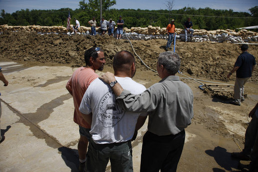 President George W. Bush pauses to talk during his visit to the flood-ravaged Iowa City, Iowa area Thursday, June 19, 2008. The President told the governor of the state, "I'm sorry we're going through this. Tell people that often times you get dealt a hand you didn't expect to have to play, and the question is not whether you're going to get dealt the hand; the question is how do you play it. And I'm confident the people of Iowa will play it really well." White House photo by Eric Draper