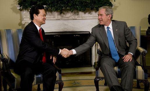 President George W. Bush exchanges handshakes with Prime Minister Nguyen Tan Dzung of the Socialist Republic of Vietnam, during their meeting Tuesday, June 24, 2008, in the Oval Office of the White House. White House photo by Eric Draper