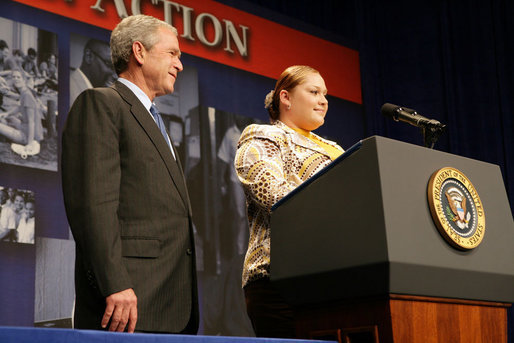 President George W. Bush listens as Edith Espinoza, Administrative Assistant, Chicano Federation, introduces him at the Office of Faith-Based and Community Initiatives National Conference Thursday, June 26, 2008, in Washington, D.C. The President opens his remarks, "How beautiful was that? From being a homeless mother of two to introducing the President of the United States. There has to be a higher power. I love being with members of the armies of compassion, foot soldiers in helping make America a more hopeful place. Every day you mend broken hearts with love. You mend broken lives with hope. And you mend broken communities with countless acts of extraordinary kindness." White House photo by Chris Greenberg