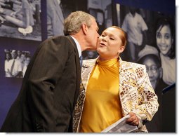 President George W. Bush gives a kiss on the cheek to Edith Espinoza, Administrative Assistant, Chicano Federation, after introducing him at the Office of Faith-Based and Community Initiatives National Conference Thursday, June 26, 2008, in Washington, D.C. The President opens his remarks, "How beautiful was that? From being a homeless mother of two to introducing the President of the United States. There has to be a higher power. I love being with members of the armies of compassion, foot soldiers in helping make America a more hopeful place. Every day you mend broken hearts with love. You mend broken lives with hope. And you mend broken communities with countless acts of extraordinary kindness."  White House photo by Chris Greenberg