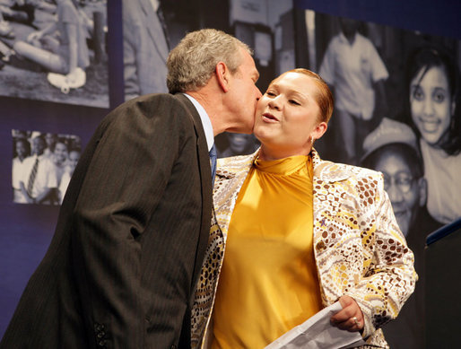 President George W. Bush gives a kiss on the cheek to Edith Espinoza, Administrative Assistant, Chicano Federation, after introducing him at the Office of Faith-Based and Community Initiatives National Conference Thursday, June 26, 2008, in Washington, D.C. The President opens his remarks, "How beautiful was that? From being a homeless mother of two to introducing the President of the United States. There has to be a higher power. I love being with members of the armies of compassion, foot soldiers in helping make America a more hopeful place. Every day you mend broken hearts with love. You mend broken lives with hope. And you mend broken communities with countless acts of extraordinary kindness." White House photo by Chris Greenberg