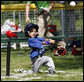 A player of the Jose M. Rodriguez Little League Angels from Manati, Puerto Rico hits the ball during the 2008 Tee Ball on the South Lawn Season Opener Monday, June 30, 2008, on the South Lawn of the White House. White House photo by Eric Draper