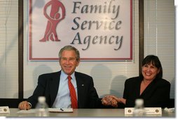 President George W. Bush holds the hand of Patty Couch during a roundtable discussion on Housing Counseling, Tuesday, July 1, 2008 at Family Service Agency Inc. in North Little Rock, Arkansas. White House photo by Joyce N. Boghosian