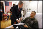 President George W. Bush shakes hands after awarding a Purple Heart medal to U.S. Marine Corps Pfc. Jacob Brittain of Frankfort, Tenn., Thursday, July 3, 2008, at the National Naval Medical Center in Bethesda, Md. White House photo by Eric Draper