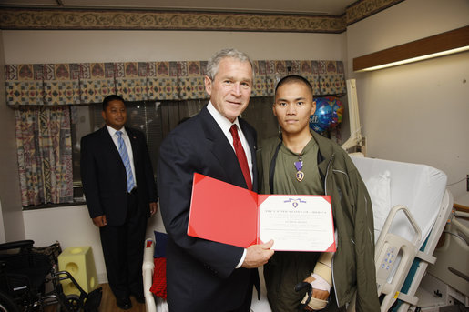 President George W. Bush awards a Purple Heart medal and citation to U.S. Navy Hospitalman Apprentice Jefferson Talicuran of Chula Vista, Calif.,Thursday, July 3, 2008, at the National Naval Medical Center in Bethesda, Md. White House photo by Eric Draper