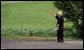 A resident of Makkari waves as the G-8 Spouses pass by en route Tuesday, July 8, 2008, to Hokkaido Marche, a farmer’s market, on Japan's northern island of Hokkaido, site of the 2008 G-8 Summit. White House photo by Shealah Craighead