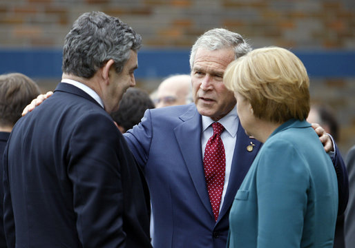 President George W. Bush speaks with Prime Minister Gordon Brown, United Kingdom, and Chancellor Angela Merkel, Germany, during the final day of the G-8 Summit Wednesday, July 9, 2008, in Toyako, Japan. White House photo by Eric Draper