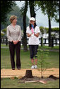 Mrs. Laura Bush stands with Natsumi Kagawa, age 11, after planting a tree at the Toyako New Mount Showa Memorial Park Wednesday, July 8, 2008, during a tree planting ceremony in Hokkaido, Japan. White House photo by Shealah Craighead