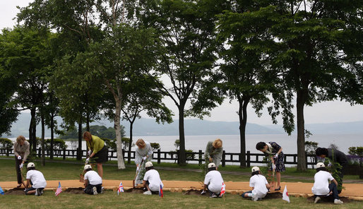 Mrs. Laura Bush, joined by other G-8 spouses, plants a tree at the Toyako New Mount Showa Memorial Park during tree planting ceremony Wednesday, July 9, 2008, in Hokkaido, Japan. Joining Mrs. Bush from left are Mrs. Sarah Brown, spouse of the Prime Minister of the United Kingdom, Mrs. Svetlana Medvedev, spouse of the President of Russia, Mrs. Laureen Harper, spouse of the Prime Minister of Canada, Mrs. Kiyoko Fukuda, spouse of the Prime Minister of Japan, and Ms. Harumi Takahashi, Governor of Hokkaido. White House photo by Shealah Craighead