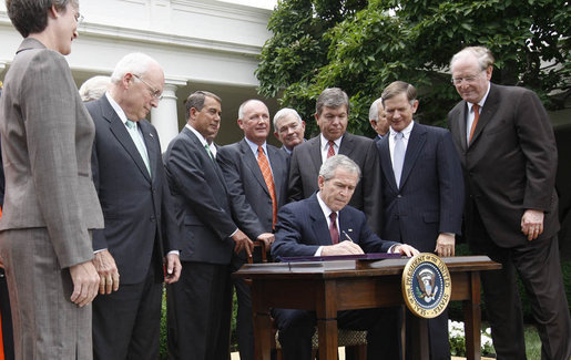 President George W. Bush, joined by members of his Cabinet and members of Congress, signs the FISA Amendments Act of 2008 Thursday, July 10, 2008, in the Rose Garden at the White House. White House photo by Eric Draper