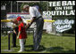 President George W. Bush and Hall of Famer Frank Robinson offer words of encouragement to 8-year-old Shelby Shayler of the Little League Challenger Division in Norfolk, Va., Wednesday, July 16, 2008, as she places a ball on the tee to start the first game of a doubleheader on the South Lawn of the White House. White House photo by Eric Draper