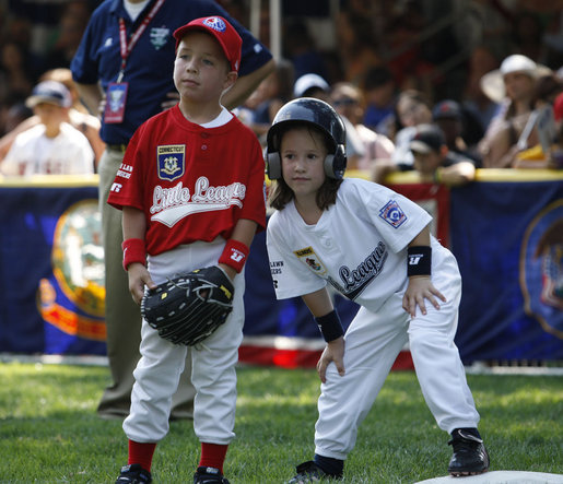 Kelsey Brauer of the Central U.S. Tee Ball All-Stars leans into first baseman Connor Hogan of the Eastern U.S. All-Stars after reaching first Wednesday, July 16, 2008, during the first game of an All-Star Tee Ball doubleheader on the South Lawn of the White House. White House photo by Eric Draper