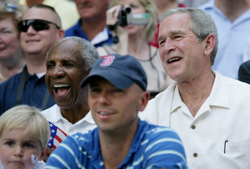 President George W. Bush and baseball Hall of Famer Frank Robinson, left, cheer on players participating in the Tee Ball on the South Lawn All-Star Game Wednesday, July 16, 2008, where the teams Eastern U.S. vs.Central U.S., and Southern U.S. vs. Western U.S., played in an afternoon doubleheader at the White House. White House photo by Chris Greenberg