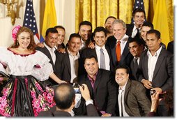 President George W. Bush poses for photos with entertainers Jorge Celedon, Jimmy Zambrano and their performance group during the celebration of Colombian Independence Day Tuesday, July 22, 2008, in the East Room of the White House. White House photo by Eric Draper