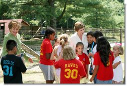 Mrs. Laura Bush, joined by North Carolina Senator Elizabeth Dole, left, greets Junior Ranger participates at a poetry reading event Monday, July 28, 2008, during a tour of the Carl Sandburg Home National Historic Site in Flat Rock, N.C. White House photo by Shealah Craighead