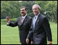 President George W. Bush walks with Pakistani Prime Minister Syed Yousaf Raza Gillani from the Oval Office to deliver their remarks Monday, July 28, 2008, on the South Lawn of the White House. White House photo by Chris Greenberg