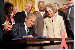 President George W. Bush is joined by Annette Lantos, right, and invited guests Wednesday, July 30, 2008 in the East Room of the White House, as he signs H.R. 5501, the Tom Lantos and Henry J. Hyde United States Global Leadership Against HIV/AIDS, Tuberculosis and Malaria Reauthorization Act of 2008. White House photo by Joyce N. Boghosian