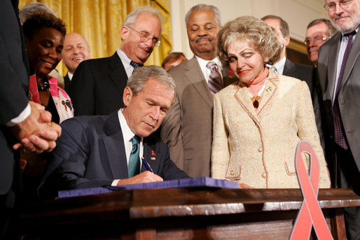 President George W. Bush is joined by Annette Lantos, right, and invited guests Wednesday, July 30, 2008 in the East Room of the White House, as he signs H.R. 5501, the Tom Lantos and Henry J. Hyde United States Global Leadership Against HIV/AIDS, Tuberculosis and Malaria Reauthorization Act of 2008. White House photo by Joyce N. Boghosian