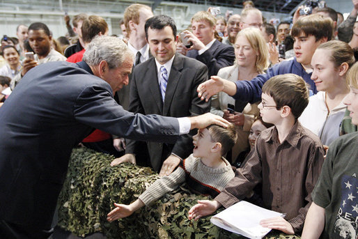 President George W. Bush pats the head of a youngster as he greets the crowd Monday, Aug. 4, 2008, after addressing military personnel at Eielson Air Force Base in Alaska. White House photo by Eric Draper