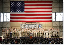 With an American flag as a backdrop, President George W. Bush addresses military personnel Monday, Aug. 4, 2008, during a stop in Alaska at Eielson Air Force Base, en route to South Korea.  White House photo by Chris Greenberg