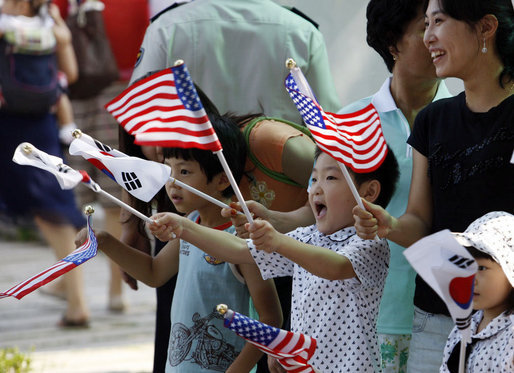 Children wave American and South Korean flags during the visit of President George W. Bush and Mrs. Laura Bush Wednesday, Aug. 6, 2008, to Seoul. White House photo by Eric Draper