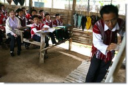 Mrs. Laura Bush sits in on a grammar class during her visit on Aug. 7, 2008 to the Mae La Refugee Camp at Mae Sot, Thailand. The camp, the largest of nine in Thailand, houses at least 39,000 Burmese refugees, many of whom home to resettle in the United States if conditions do not permit them to return to their home country. White House photo by Shealah Craighead