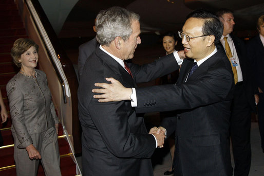 President George W. Bush and Mrs. Laura Bush are greeted by China's Foreign Minister Yang Jiechi, upon their arrival Thursday, Aug. 7, 2008, at Beijing Capitol International Airport in Beijing, where they will attend the opening ceremonies for the 2008 Summer Olympic Games on Friday. White House photo by Eric Draper