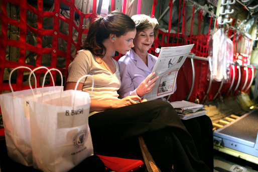 Mrs. Laura Bush and her daughter Ms. Barbara Bush go over information on the plane as they fly to Thailand on Aug. 7, 2008. The visit highlighted the problems facing the Burmese refugees living inside the Thailand border in nine refugee camps. It has been 20 years since the Aug. 8, 1988 crackdown in Burma. Since 2005 alone, a little over 30,000 Burmese have moved to the United States to find a home and escape the dire conditions. White House photo by Shealah Craighead