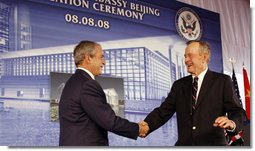 President George W. Bush is welcomed to the podium after an introduction by former President George H.W. Bush Friday, Aug. 8, 2008, at the dedication for the U.S. Embassy in Beijing. White House photo by Eric Draper