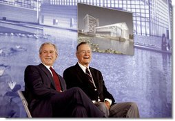 President George W. Bush and former President George H.W. Bush sit on stage at the U.S. Embassy in Beijing Friday, Aug. 8, 2008, during dedication ceremonies. Both are scheduled to attend opening ceremonies scheduled for later in the evening. White House photo by Eric Draper