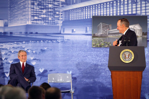 President George W. Bush smiles during an introduction by his father, former President George H.W. Bush Friday, Aug. 8, 2008, during the dedication of the United States Embassy in Beijing. White House photo by Eric Draper