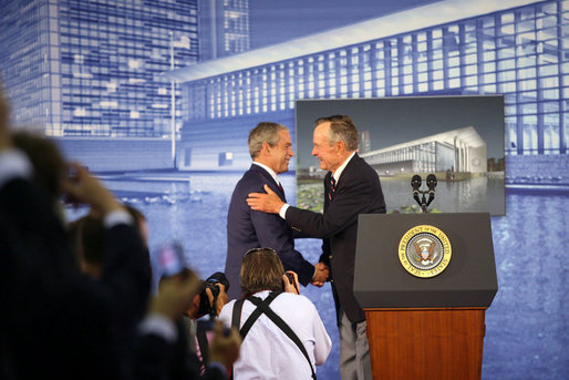 Former President George H.W. Bush embraces President George W. Bush after introducing his son during dedication ceremonies Friday, Aug. 8, 2008, at the U.S. Embassy in Beijing. White House photo by Shealah Craighead