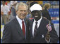 President George W. Bush poses for a photo with U.S. Olympic runner Lopez Lomong Friday, Aug. 8, 2008, in Beijing prior to Opening Ceremonies of the 2008 Summer Olympic Games. Lopez Lomong, a survivor of the violence in his native Sudan, now a U.S. citizen, was selected by his teammates to lead the U.S. Olympic team into Olympic National Stadium carrying the United States Flag at the Opening Ceremony. White House photo by Eric Draper