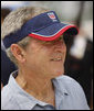 President George W. Bush sports a thank-you note on his visor, courtesy of the U.S. Beach Volleyball team as he watches practice Saturday, Aug. 9, 2008, at Chaoyang Park in Beijing. White House photo by Eric Draper