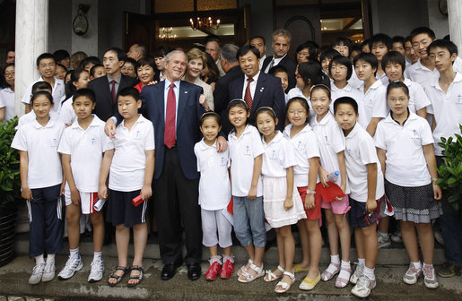 President George W. Bush and Mrs. Laura Bush stand outside the Kuanjie Protestant Christian Church with members of the Kuanjie Summer Vacation School Choir after attending services Sunday, Aug. 10, 2008, in Beijing. White House photo by Eric Draper