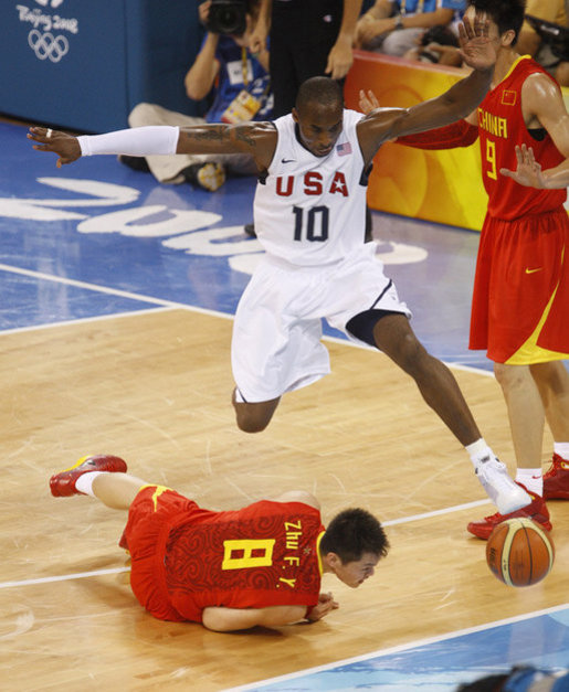 U.S. Olympic Men's Basketball team member Kobe Bryant leaps over a member of China's team chasing for a loose ball Sunday, Aug. 10, 2008, during action in the Group B men's Olympic basketball game between the U.S. and China, at the 2008 Summer Olympic Games in Beijing. White House photo by Eric Draper