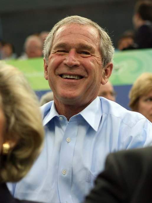 President George W. Bush smiles in response to the waves from the U.S. athletes after arriving Sunday, Aug. 10, 2008, at the National Aquatics Center in Beijing. White House photo by Shealah Craighead