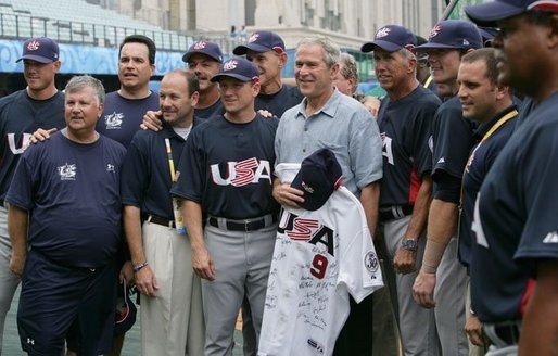 President George W. Bush poses for a photo with the U.S. Olympic men's baseball team and their manager Davey Johnson, right, prior to a practice game with the Chinese Olympic men's baseball team Monday Aug. 11, 2008, at the 2008 Summer Olympic Games in Beijing. The U.S. Olympic men's baseball team presented President Bush with a U.S. Olympic baseball hat and an autographed U.S. Olympic baseball jersey. White House photo by Chris Greenberg