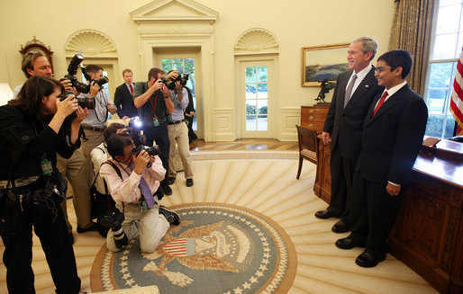 President George W. Bush stands with Sameer Mishra, 14, of Lafayette, Ind., during his visit Wednesday, Aug. 13, 2008, to the Oval Office of the White House. The teen was named the 2008 Scripps National Spelling Bee Champion in the 16th round after correctly spelling the word "guerdon," meaning a reward or recompense). White House photo by Joyce N. Boghosian